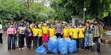 Maid In India Leads Cleanliness Drive at Delhi Protest Site. Yellow T-Shirts, Blue Bags, One Mission.